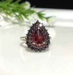 Vintage Sterling Silver Natural Dark Red Garnet Ring....Marked 925... Size 6...Total of weights 4.2grams...Measure of Face 17.6MM...It's in very good condition. Red Pear-shaped Ring For Formal Occasions, Pear-shaped Red Rings For Formal Occasions, Formal Red Pear-shaped Ruby Ring, Formal Pear-shaped Ruby Ring, Formal Red Pear-shaped Ring, Classic Pear-shaped Red Rings, Classic Red Pear-shaped Rings, Classic Red Garnet Cluster Ring, Red Garnet Cluster Ring