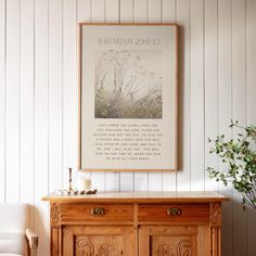 a wooden cabinet sitting next to a wall with a poster on it's side