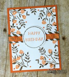 an orange and white birthday card with flowers on it