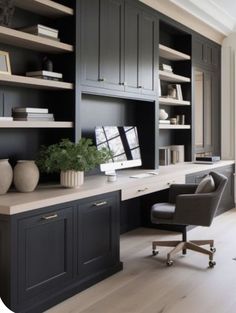 a home office with built in shelving and desk