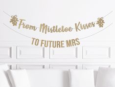 a room with white walls and gold foil lettering that says from mittlee kisses to future mrs