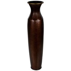 a tall brown vase sitting on top of a table