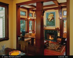 a living room filled with furniture and a fire place in the middle of a room