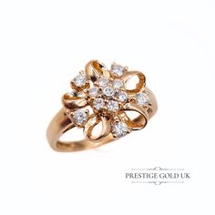 ** Visit Our Store → https://www.etsy.com/shop/prestigegolduk ** Any boxes are for display purposes only  This stunning 14ct rose gold ring is in fantastic condition, adorned with twelve cubic zirconia stones arranged in a beautiful flower design. A statement ring, the floral detail measures approximately 15mm across, yet the ring is a very wearable 4.2 grams.  This ring is fully hallmarked in Birmingham, a testament to its quality and craftsmanship. A perfect addition to your collection or a th Elegant Gold Flower Ring With Diamond Cut, Formal Yellow Gold Flower Ring With Cubic Zirconia, Rose Gold Hallmarked Flower Ring For Wedding, Gold Flower Ring With Brilliant Cut For Wedding, Rose Gold Cubic Zirconia Flower Ring For Formal Events, Elegant Gold Plated Flower Ring For Wedding, Classic Gold-plated Diamond Ring For Wedding, Classic Gold Plated Diamond Ring For Wedding, Classic Rose Gold Cluster Ring As Gift