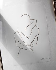 a drawing of a person holding their arms around each other's shoulders, in front of a sheet of paper