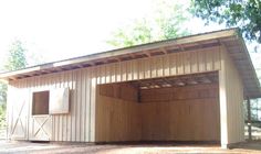 a horse barn with the doors open