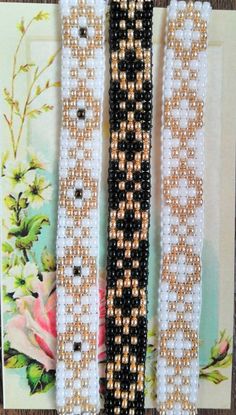 three beaded bracelets sitting next to each other