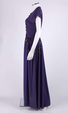 For Sale on 1stDibs - Vintage Couture c.1940's purple button front floor length evening gown. Extended shoulders. High v-neckline. Eight center front covered dome button closures. Formal Purple Dress With Buttons, Elegant Purple Dress With Button Closure, 1940 Evening Gowns, Black And Purple Vintage Dress, Purple Historical Dress, 1930s Purple Dress, 1940s Outfits, Gold Belts, Vintage Couture