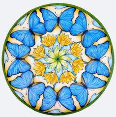 a blue and yellow glass plate with butterflies on the inside, in a circular pattern