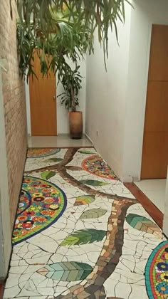 the hallway is decorated with colorful tiles and plants in potted planters on either side