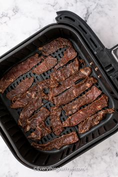 the steaks are being cooked in an air fryer