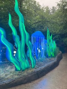 an art installation in the shape of jelly fish and corals on display at a park