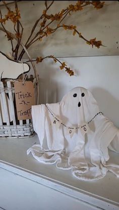 a white shelf topped with lots of halloween decorations