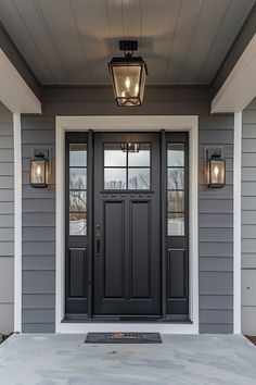 the front door of a house with two lights on each side and one light above it