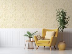 a yellow chair sitting next to a potted plant