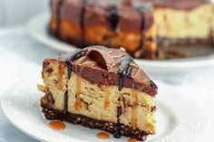 a piece of cheesecake on a plate with caramel drizzle and chocolate