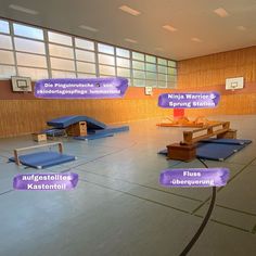 an empty basketball court with benches and other things on the floor in front of it