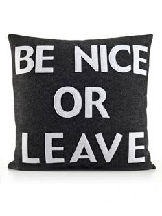 a black and white pillow that says be nice or leave