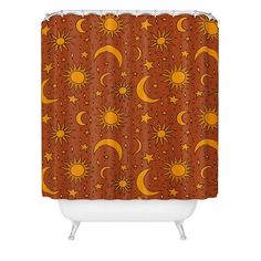 a shower curtain with the sun and moon pattern in orange, yellow and brown colors