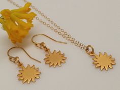 "Our gift to you 10% off your first purchase. Details here - http:/eepurl.com/dpVPBz Our dainty sun necklace in gold or silver is sure to brighten your day. This sun pendant necklace moves freely on a delicate but sturdy chain. Wear this tiny sun charm as a layering piece or alone as a simple statement necklace. DETAILS Necklace features a 1/2\" 24 k gold plate or sterling silver sun charm pendant 14 k gold fill or sterling silver chain dainty but sturdy chain This listing is for one sun necklac Gold Sun Earrings, Bridal Party Shoes, Simple Statement Necklace, Boho Bridal Jewelry, Interlocking Circle Necklace, Necklace Sun, Dainty Gold Earrings, Single Pearl Necklace, Sun Earrings