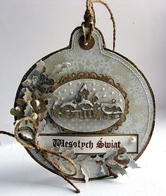 a christmas ornament hanging from a string on a white background with words written below it