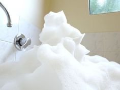 a close up of a white towel on a bathtub