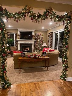 the living room is decorated for christmas with garlands and decorations on the fireplace mantel