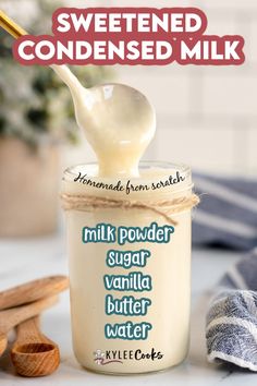 a glass jar filled with homemade sweetened condensed milk and topped with a wooden spoon