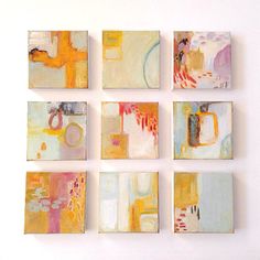 six square paintings are arranged on the wall