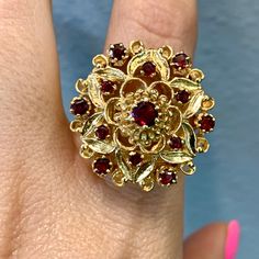 Metal: 14kt Yellow Gold                                                                                                                                                                                                                                                                                                                                Weight Of Ring Including Gems: 12.80 grams                                                                                                                                                                                                                                                                                                                                          Stone: Garnet Shape: Round Collectible Ruby Ring In Fine Jewelry Style, Collectible Fine Jewelry Ruby Ring, Red Hallmarked Cluster Ring, 14k Stamped Ruby Ring, Garnet Rings, Rings Statement, Garnet, Statement Rings, Ring Size