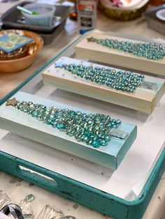 three pieces of beaded jewelry sitting on top of a table next to each other