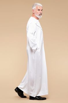 A classic Omani Thobe made from Korean material, with a satin finish. The design is cut to a tailored fit and finished with high-quality embroidery across the chest.   HEIGHT OF MODEL: 187 cm. / 6' 1" Size 60/Large Colour: White & Grey Style: Casual wear Composition: 100% Polyester Care: Machine Washable Signature details: Press buttons, 2 side pockets. Hijab Caps, Grey Style, Of Model, British Indian, Health And Wellbeing, Grey Fashion, Bosnia And Herzegovina, Ghana, Casual Wear