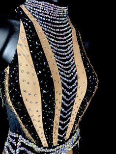 a black and gold dress with beads on it