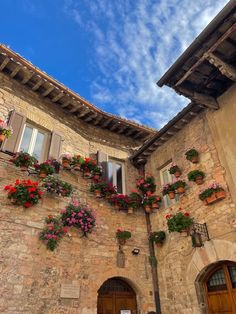 an old building with flower boxes on the side