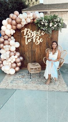 a woman sitting on a chair in front of a sign that says happy to be