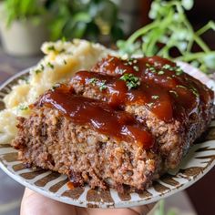 a plate with meatloaf and mashed potatoes on it