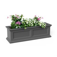 a planter filled with lots of flowers on top of a white surface