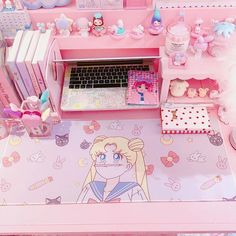 a pink desk topped with lots of toys