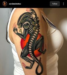 a woman's arm with a tattoo on it that has an image of a lizard