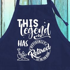 an apron that says, this legend has retired on the front and is blue with white lettering