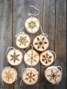 wooden ornaments with snowflakes hanging from strings