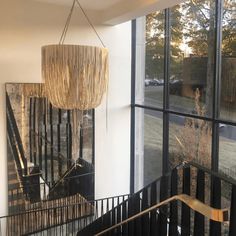 a chandelier hanging from the side of a staircase