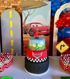 cars birthday cake and party decorations on a table