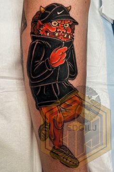 a man's arm with a tattoo of an animal wearing a hat and coat