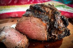 a piece of meat sitting on top of a wooden cutting board