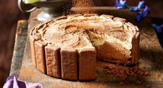 a cake sitting on top of a wooden cutting board