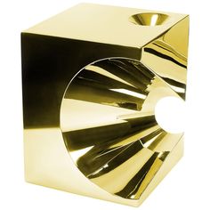 a golden object that is shaped like a cube