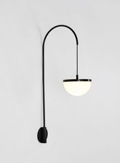 a black wall lamp with a white light on it