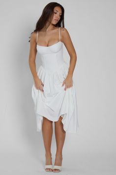 Introducing our Ballerina Bustier Midi Dress - a classic, feminine dress option for any occasion. From brunch parties to evening events, this white midi dress is complimented with wire bustier cups that skim down to a tight fit that cinches at the waistline. The skirt silhouette features a gathered detail that falls to a midi length making it an elegant dress meant to last in your wardrobe forever. Perfer mini length? Try our "Bellini Dress" - same style, just in mini length. High Waist Long Skirt, White Midi, Long Skirt Outfits, Plain Dress, Bodycon Floral Dress, Bustier Dress, Feminine Dress, White Midi Dress, Types Of Dresses