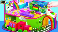 a kid's play house with lots of toys in it and a rainbow train